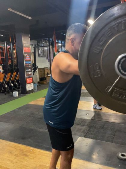 A close-up of a drop snatch, showing the lifter moving his body under the bar rather than lifting the bar higher.