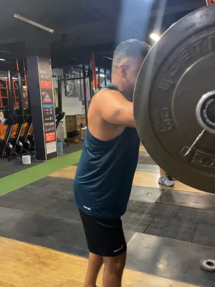 A close-up of a drop snatch, showing the lifter moving his body under the bar rather than lifting the bar higher.