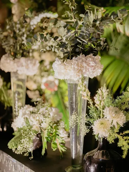 For our 'Love & Illusion' Sangeet, we used clean, modern floral arrangements with white hydrangeas and roses to complement the monochrome theme. Sometimes, simplicity is the ultimate sophistication.