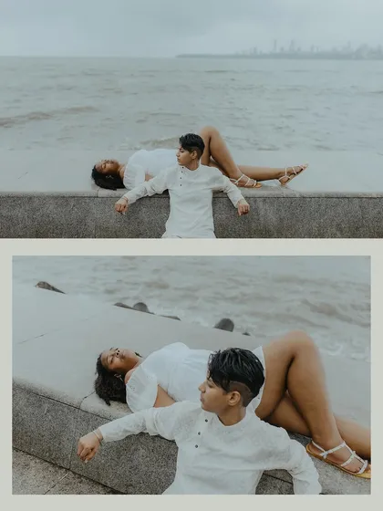 A creative and peaceful composition of the couple relaxing by the sea wall, capturing a moment of calm and connection.