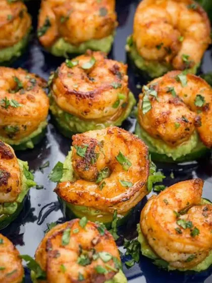 A close-up of our perfectly seared sriracha prawns served on a bed of fresh avocado. Each appetizer is a testament to our commitment to flavor and presentation, designed to be a memorable single bite.