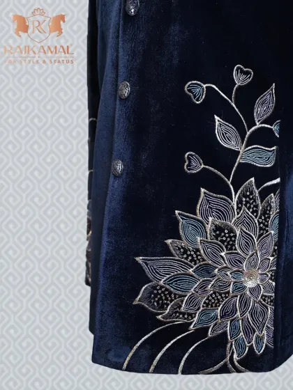 A side view of the navy blue velvet Bandhgala, showing the placement of the floral embroidery on the lower half of the jacket.