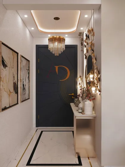 A luxurious foyer design with a custom-monogrammed door, a stunning butterfly wall installation, and an elegant chandelier for a glamorous entrance.