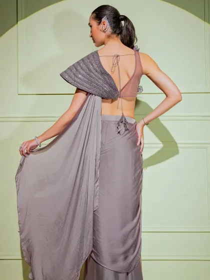 The back view of a grey drape saree with a unique, architecturally pleated blouse, showcasing my commitment to innovative design.