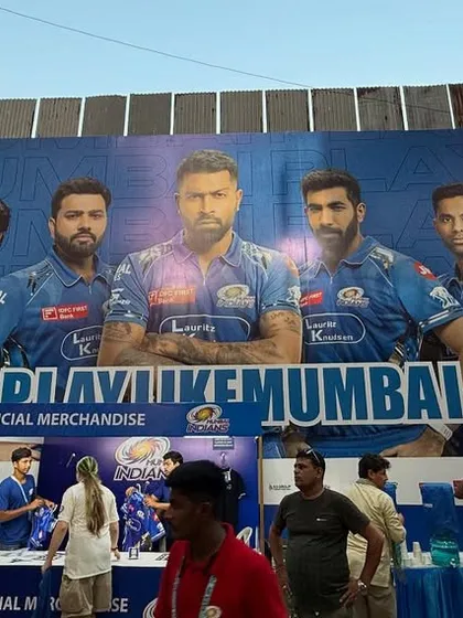 The main campaign image featuring the full team, displayed as a large-scale banner for official merchandise stalls.