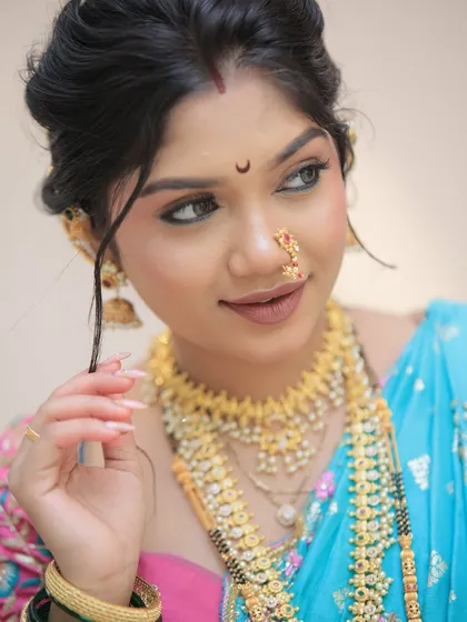 For this client's traditional Maharashtrian look, we chose long, elegant almond-shaped nail extensions with a natural, glossy finish. This style adds grace and completes the look without overpowering the beautiful saree and jewelry.