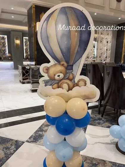 A cute teddy bear in a hot air balloon prop. This standalone piece is great for adding detail to a welcome baby or first birthday party, and it serves as a lovely photo opportunity.
