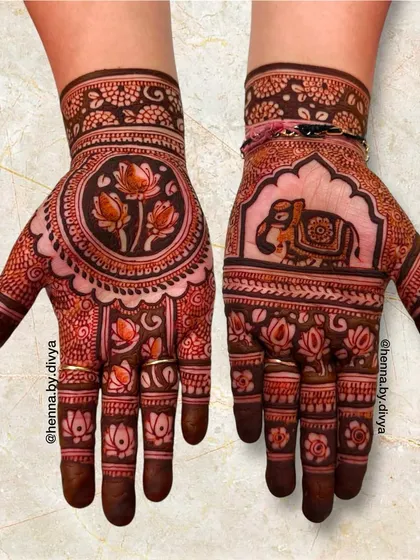 A stunning design combining a royal elephant on one palm with a lotus mandala on the other. The fingers are covered in lotus patterns, tying the two hands together.