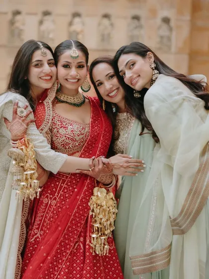 A bride surrounded by her bridesmaids, sharing a moment of love and support. We know how important your support system is.