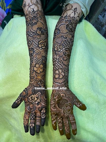 A beautiful design featuring a mix of roses and other flowers, with a lovely border at the top of the arms.