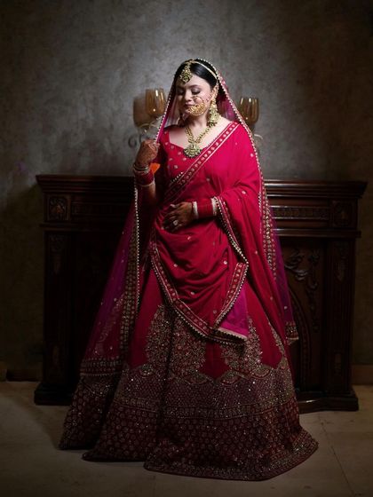 An elegant bridal portrait by a fireplace, the warm, classic setting complementing her traditional attire.