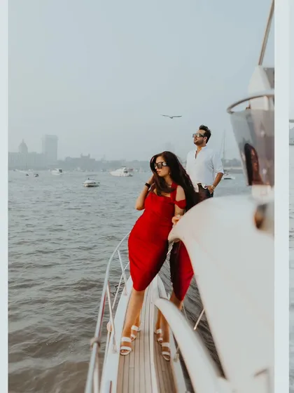 A stylish pre-wedding shoot on a yacht in Mumbai, with the city's skyline in the background.