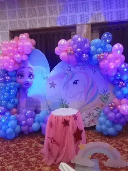 A magical party setup combining the worlds of Frozen and unicorns. I used custom backdrops for both themes and surrounded them with balloon garlands in coordinating shades of blue and purple.