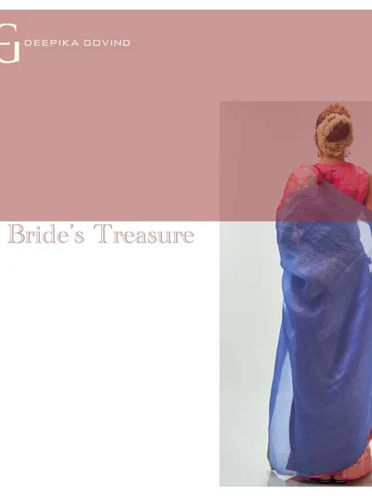 A view from the back, this image captures the striking color contrast of the absolute coral and blue tissue saree. The design is modern, yet deeply rooted in the tradition of handwoven textiles.