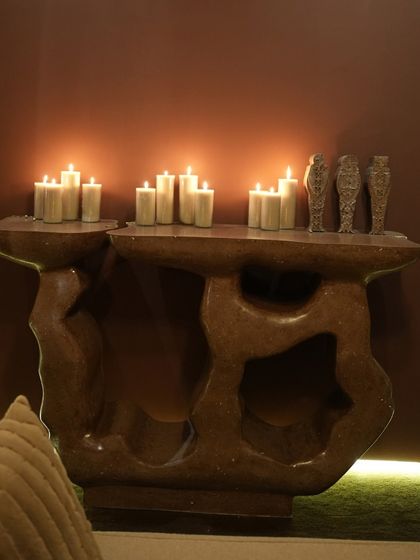 The Rooh Console in a cozy setting. Its unique form and earthy tones make it a perfect centerpiece, adding a touch of artistic flair and natural beauty to the room.