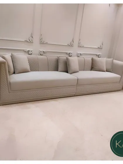 We designed this expansive, custom-sized sofa with a unique quilted pattern on the frame, offering a subtle yet luxurious texture. Its neutral upholstery and clean lines make it a versatile centerpiece, built to provide exceptional comfort in a large residential living room.