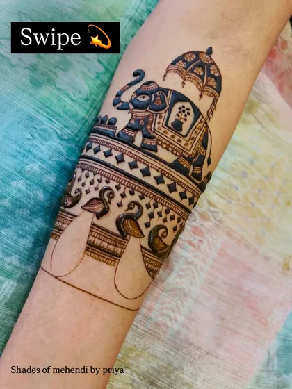 The outline of the royal elephant and peacock motifs before the detailed filling. This shows the foundation of a clean and precise bridal design.