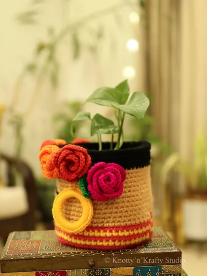 A side view of the Frida Basket, showing the colorful flowers and striped details that wrap around it. It's a piece of functional art for your home.