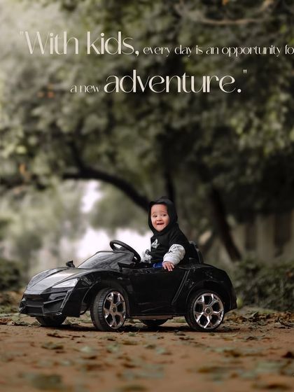 With kids, every day is an opportunity for a new adventure. A happy boy in a hoodie enjoys a ride in his toy car.
