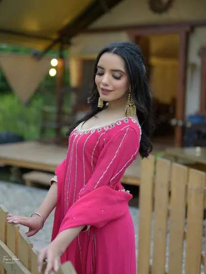 A soft and romantic look in a pink suit. The makeup is kept minimal to match the delicate embroidery on the outfit.