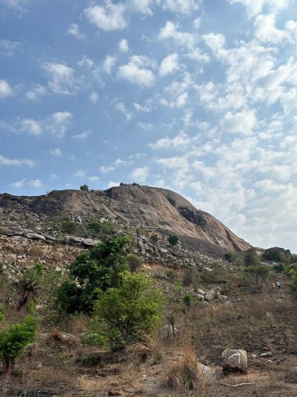The rocky landscape of Minchukallu Betta under a partly cloudy sky. It's a great short trek near Bangalore.