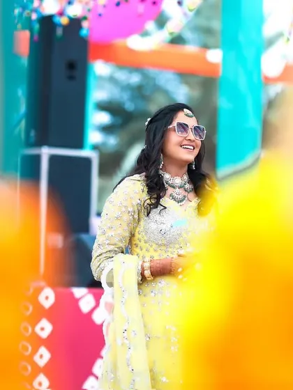 The bride shines in a yellow outfit at her vibrant Rajasthani-themed Mehendi carnival.