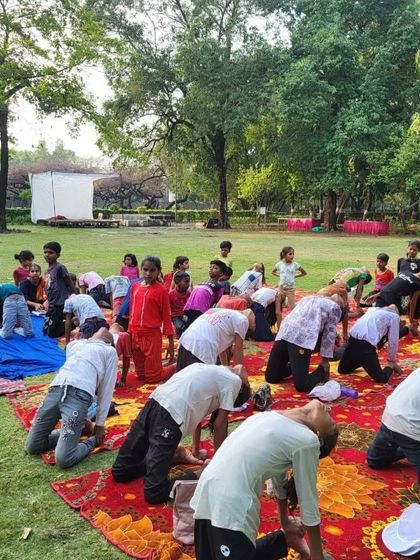Children practicing Shashankasana (Child's Pose) during our outdoor NGO session. This is a wonderful resting pose that helps to calm the mind and relieve stress.