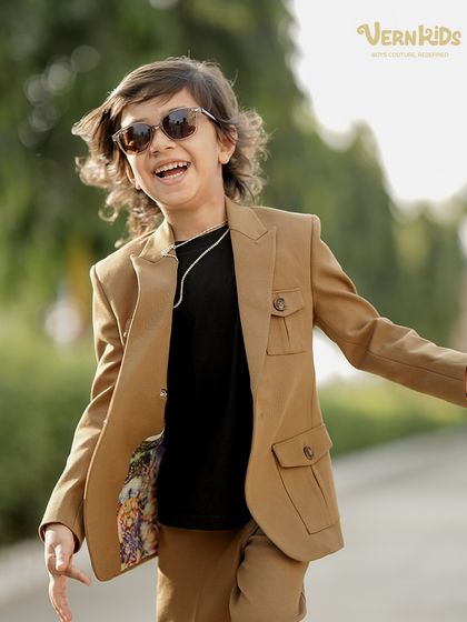 A handsome little star in his custom-made shacket set. This image shows the final product of our design process, a unique outfit for a unique child.