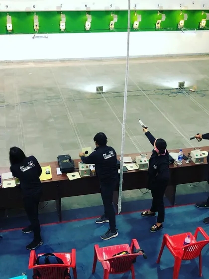 An overhead view of our shooters during a championship in Rohtak. This perspective shows the organized, professional setup of a competitive event, an environment we prepare our athletes for.