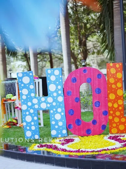 Every angle is an opportunity for a great photo. This shot shows the custom "HOLI" sign from a different perspective, highlighting how such installations can anchor the decor and become a focal point for the event.