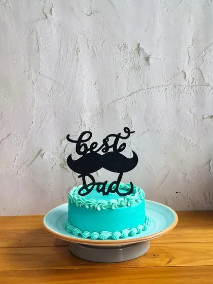 For the "Best Dad" ever, this Father's Day cake with a fun mustache topper is a playful and sweet way to celebrate him.