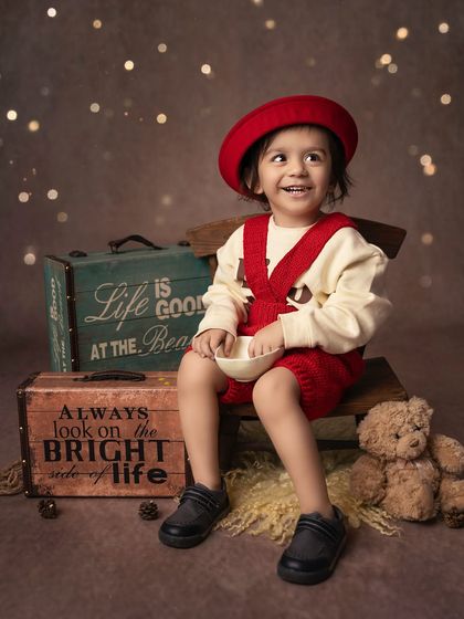 This toddler's joyful expression is priceless. While he's the star, this shot is part of a larger sibling session, capturing his individual personality.