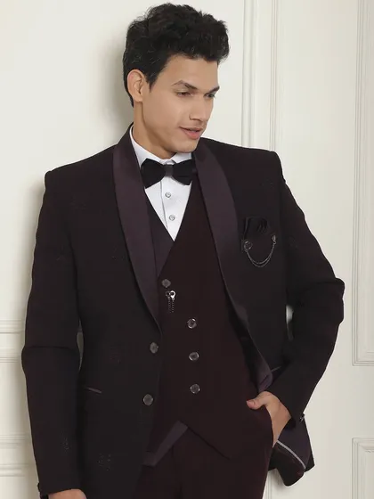 A closer look at the wine-colored tuxedo, showing the texture of the fabric and the fit of the jacket. It's all about a dream fit.