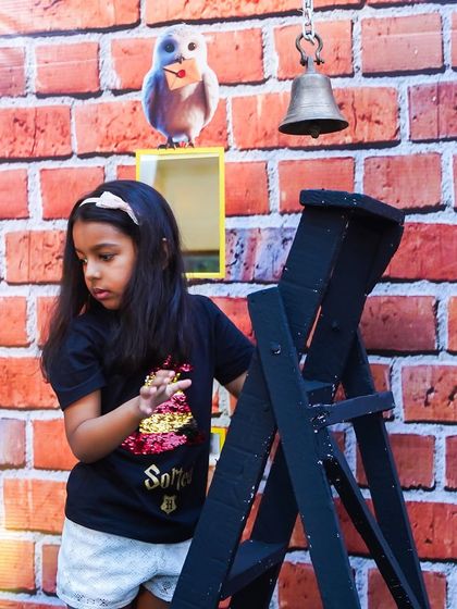 A fun, interactive game where a young guest rings a bell at the "Owl Post Office," another creative station from the Harry Potter party.