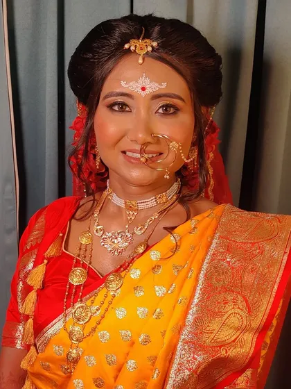 A smiling portrait of the happy bride, her eyes shining with golden eyeshadow.