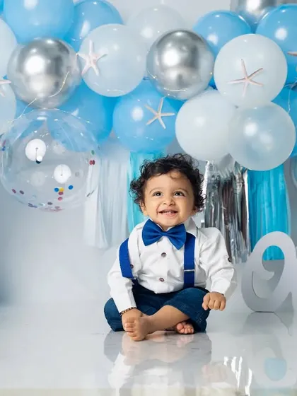 A sweet, happy smile from the one-year-old. Our custom balloon arrangements are designed to perfectly match your chosen birthday theme.
