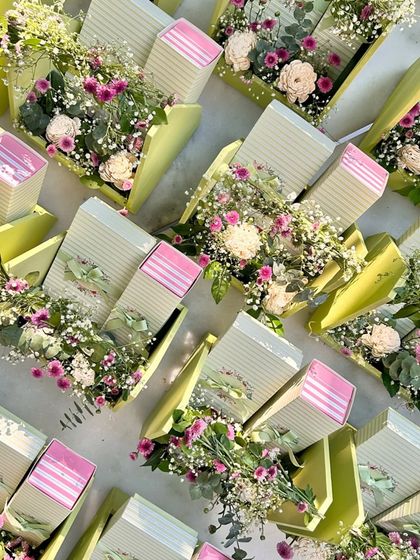 Celebrate the season of giving with our elegantly crafted floral gifts. This large order of green and pink hampers was designed for a special celebration.