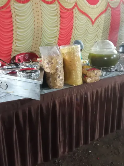 A simple and effective chaat counter setup for an event. It includes pani puri, puris, and other ingredients ready for guests to enjoy.