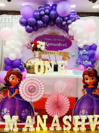 A 'Sofia the First' princess theme in her signature purple. This setup includes life-size character cutouts and a beautiful balloon arch.