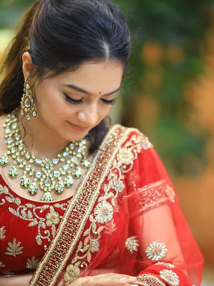 The bride looks down, showcasing the delicate lashes and soft eyeshadow.