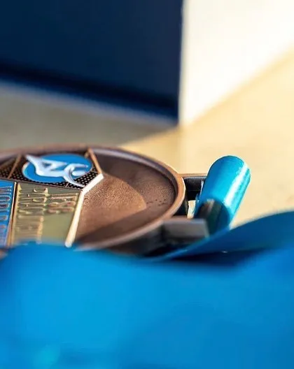 A close-up of the bronze medal from the World Cup in Villars. This represents countless hours of training, dedication, and the support of so many people.