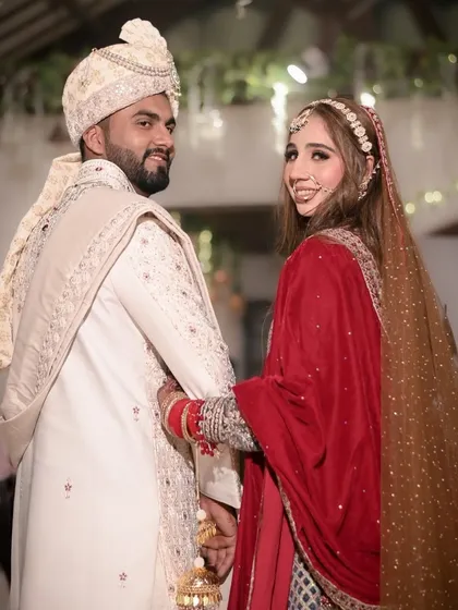 "Lead the way." A beautiful shot of the couple looking back as they begin their new life together. This image captures the connection and shared excitement of a Muslim bride and groom.
