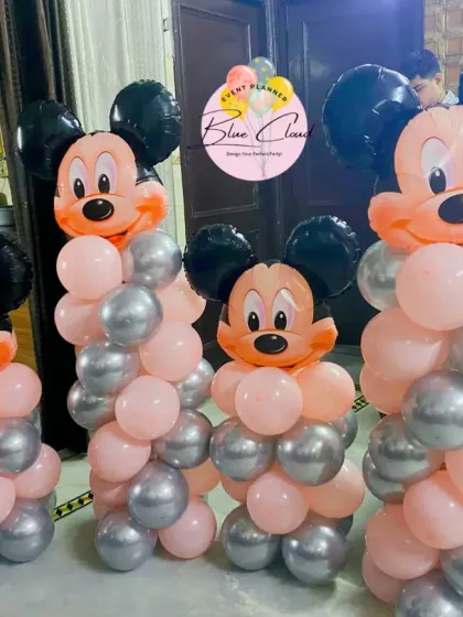 A set of four Mickey Mouse balloon pillars in pink and silver, perfect for adding character to any party space.