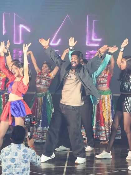 The grand finale of our annual show is always a celebration. Here I am on stage with the entire team of performers, sharing the energy and excitement with the audience.