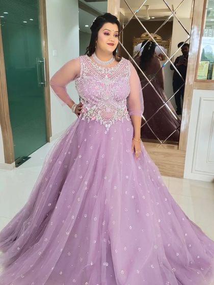 A full shot of the reception gown. The intricate silver embroidery on the bodice is the centerpiece of this look.