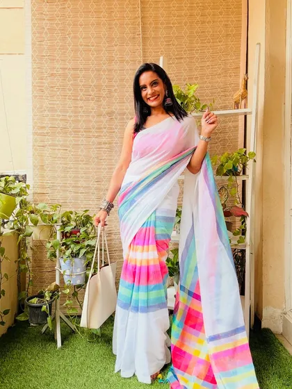 This white cotton Mulmul saree with a colorful pastel rainbow pattern is so dreamy and pretty. It's a perfect summer saree for a day out.