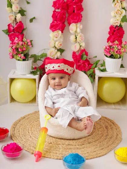 Capturing the vibrant spirit of Holi with a safe and colorful studio setup. This little one is all dressed up for his first festival of colors, complete with a pichkari and bowls of bright, baby-safe powder.