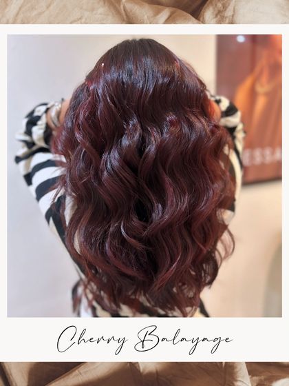 Scale up your style with a vibrant Cherry Balayage. This look is the perfect blend of luxury and boldness, for those who aren't afraid to stand out.