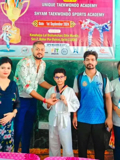 A student receives his medal at the Vijay Cup. We encourage participation to build experience.