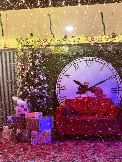 The Christmas photo booth with an artificial snow effect, creating a magical winter scene.